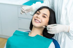 dentist evaluating patient's teeth