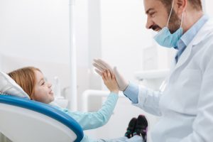 girl high fiving dentist